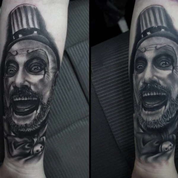 Black and grey portrait tattoo of Captain Spaulding in a top hat.