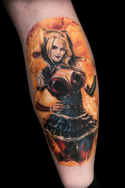 Colour Harley Quinn tattoo with a bat and a vivid orange flame background.